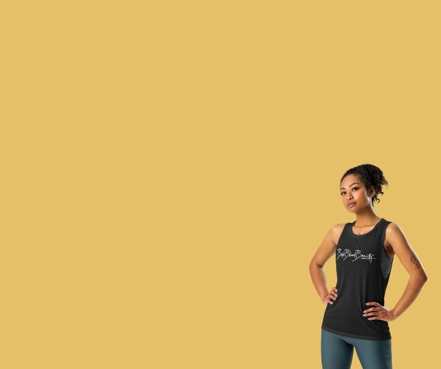 A female model stands confidently with one hand on her hip, wearing a black sleeveless top featuring the Bold Blind Beauty logo in white script. She is positioned on the lower right against a solid mustard yellow background. To her left in white text is "Shop bestsellers--Step boldly into your journey--where creativity, curiosity, and courage lead to extraordinary possibilities." A Shop Now button is under the text.